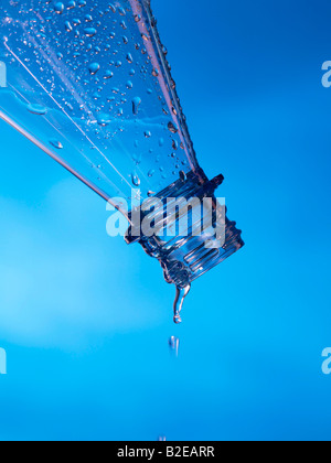 Close-up of water droplets being poured from bottle Stock Photo