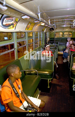 Black boy sits in Rosa Parks city bus seat on display at The Henry Ford Museum in Dearborn Michigan Stock Photo