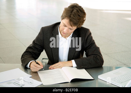 Close-up of a businessman working at a desk Stock Photo