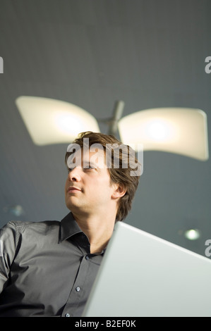 Low angle view of a businessman working on a laptop Stock Photo
