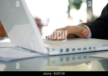 Close-up of a businessman's hand using a laptop Stock Photo