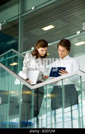 Businessman and a businesswoman looking at the documents Stock Photo