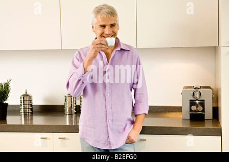 Mature man drinking tea in the kitchen Stock Photo