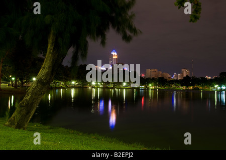 Sky scapers at night viewed from Lumpini park, Bangkok, Thailand Stock Photo