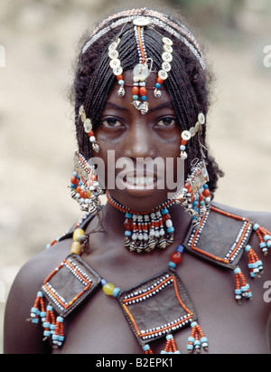 A young Afar girl at Senbete market. Her elaborately decorated hairstyle and beaded jewellery are typical of unmarried girls. Stock Photo