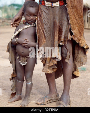 A Nyag'atom mother and young daughter in typical dress.  Rugged skin clothing is still widely used. Stock Photo