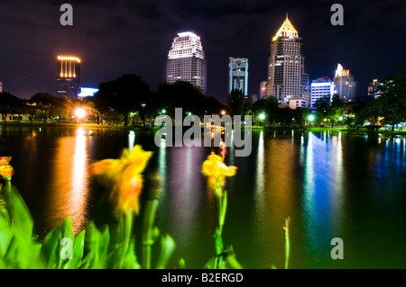 Skyscapers at night viewed from Lumpini Park, Bangkok Stock Photo