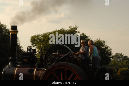 Two people driving a steam engine Stock Photo - Alamy