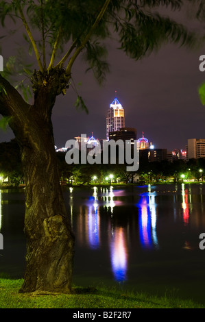 Sky scapers at night viewed from Lumpini park, Bangkok, Thailand Stock Photo