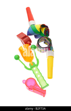 Colorful party horn blowers whistles and click clack on white Stock Photo