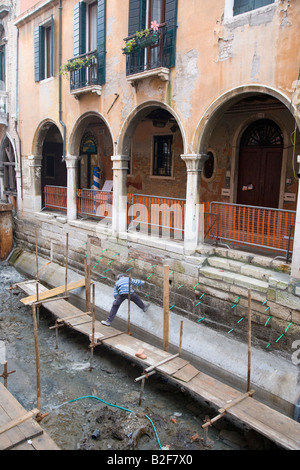 Canal repair works to drained canals Venice Italy Stock Photo