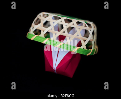 Origami rabbit caught in a basket. Stock Photo