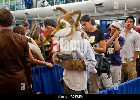 Wearing a fox head a costumed visitor at Comic Con International at the San Diego Convention Center draws an amused glance right Stock Photo