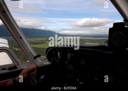 Flight seeing trip with small air plane plane over the Knik River valley towards Knik River Glacier, Palmer, Alaska, USA Stock Photo