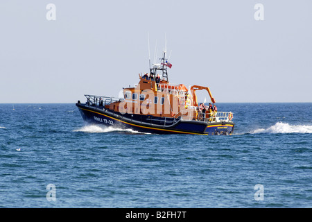 An RNLI All Weather off shore Lifeboat in Weymouth bay out on a search and rescue mission Stock Photo