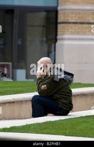 Asian man on the phone outdoors Stock Photo