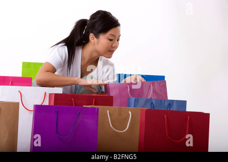 Young woman looking into a shopping bag Stock Photo