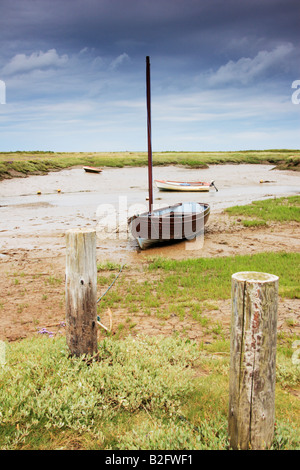 Boats on a dried out creek at Morston Quay in Norfolk, England. Stock Photo