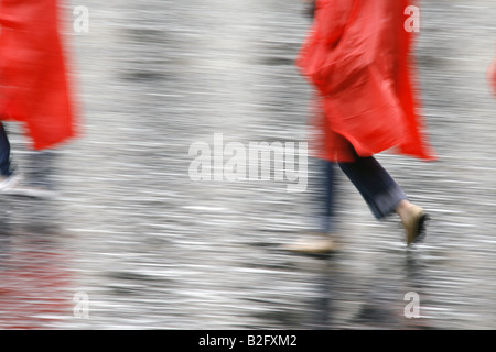 couple wearing waterproof coat capes in rain Stock Photo