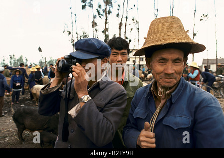 asian farmers at a cattle sale, taking a photograph, and doing thumbs-up Stock Photo