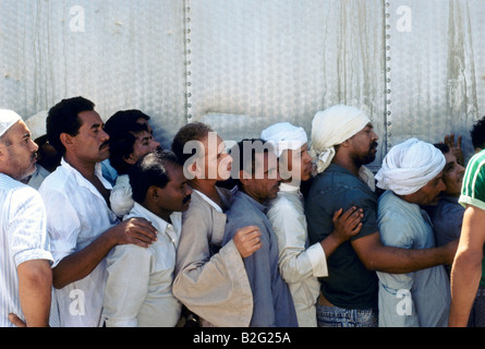 jordanian men queue for bread hand out in refugee camp during the gulf crisis Stock Photo