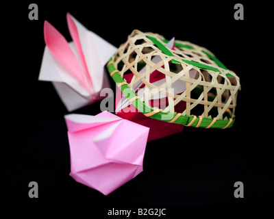 Origami rabbits and a basket. Stock Photo