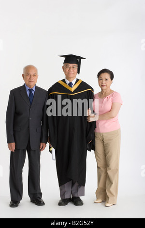 Portrait of a senior male graduate standing with his friends Stock Photo