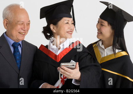 Professor with his two female university students smiling Stock Photo