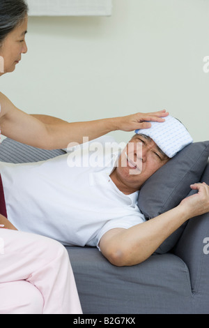 Senior woman taking care of a senior man Stock Photo
