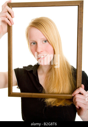 blond attractive pretty woman picture frameJunge Frau mit langen blonden Haaren schaut durch einen leeren Holzrahmen Model Anne
