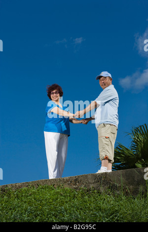 Portrait of a mature woman with a senior man standing and holding each other's hands Stock Photo