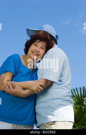 Mature woman and a senior man embracing each other Stock Photo
