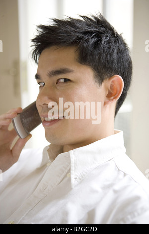 Portrait of a young man using cellphone Stock Photo