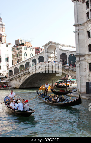 Tourists enjoying an evening ride on a gondola in Venice, Stock Photo