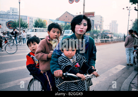 mother and children on bicycle in china Stock Photo