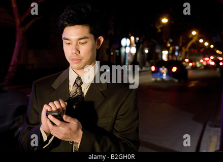 A young businessman text messaging Stock Photo