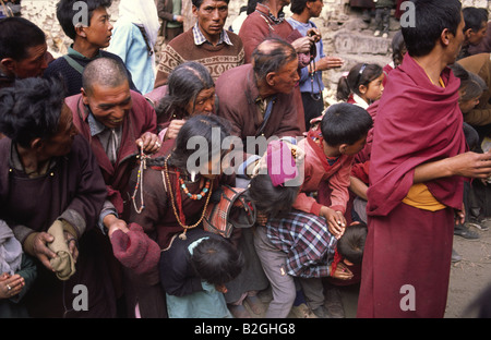 Pilgrims bow as a 'Rimpoche', (a reincarnation of a high Lama) enters the Monastery. Leh, Ladakh, Jammu & Kashmir state, India. Stock Photo