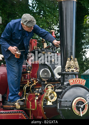 Man servicing a Fowler steam tractor at Masham Steam Engine and Fair Organ Rally. Stock Photo