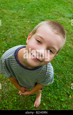 Young boy looking up at the camera Model Released Stock Photo