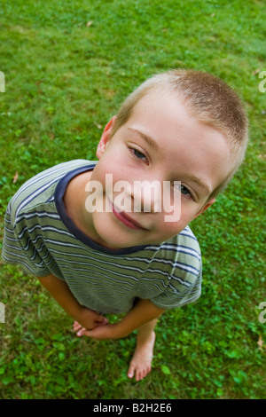 Young boy looking up at the camera Model Released Stock Photo