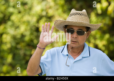 Portrait of a mature man waving his hand Stock Photo