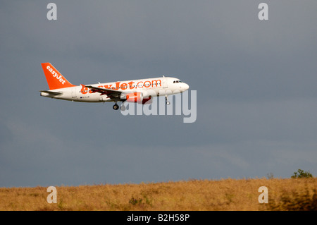 easyJet Airbus A319 Stansted heat haze effect appearing to land on a hilly wheat field