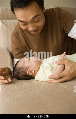 Close-up of a mid adult man playing with his daughter Stock Photo