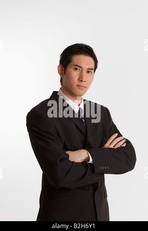 Portrait of a businessman standing with his arms crossed Stock Photo ...