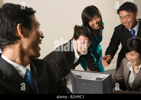 Business executives working in an office and smiling together Stock Photo