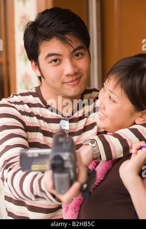 Young couple filming themselves Stock Photo