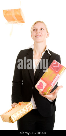 businesswoman business woman jugglery juggling blond young attractive tradeswoman presents laughing smiling gifts Stock Photo