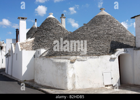 Trulli houses with a blue sky in the background and white puff clouds,Alberobello,Puglia, Italy Stock Photo