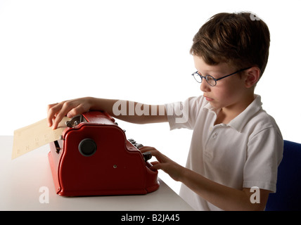 A visually impaired blind school boy using a braille machine brailler Stock Photo