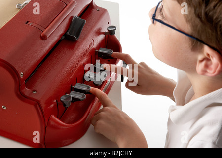 A visually impaired blind school boy using a braille machine brailler Stock Photo